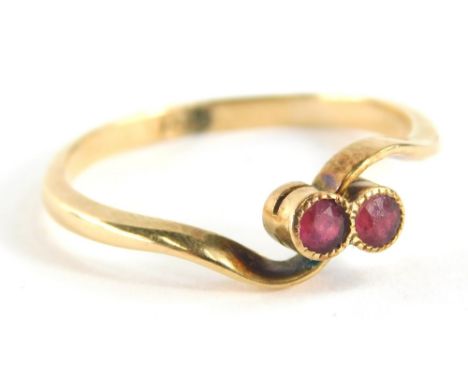 An 18ct gold garnet set twist ring, with two rubies in rub over setting, with twist shoulders, ring size P, 2.4g all in.