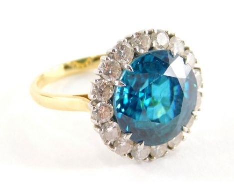 A blue zircon and diamond cluster ring, with central blue zircon totalling 13.1cts, within a border of sixteen round brillian