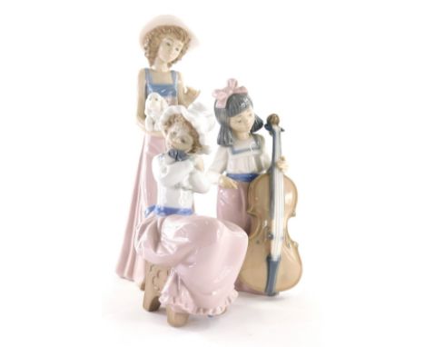 Various Nao figures, comprising a girl in standing pose holding puppy, 26cm high, another cuddling puppy and another figure o