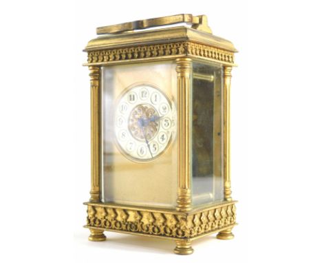 An early 20thC brass cased carriage clock, the fancy dial with 5cm diameter Arabic numerals, in a four pillared five glass ca