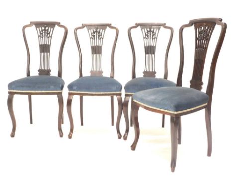 A set of four Edwardian mahogany side chairs, each with a pierced vase shaped splat, on a padded seat on cabriole legs.