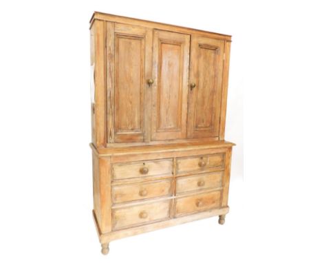 A 19thC rustic pine kitchen cabinet, with three panel doors raised with six short drawers on turned feet, 195cm high, 135cm w