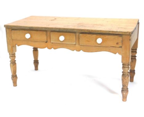 A late 19thC pine kitchen or dairy table, with plank top raised above frieze drawers with ceramic handles on turned legs, 78c