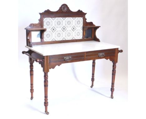 An Edwardian tile back and marble top washstand, with two frieze drawers, on turned legs with side towel rails, 128cm high, 1