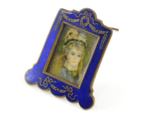 An early 20thC miniature enamel frame, in blue with gilt highlights, containing a portrait of a lady wearing hat, with plain 