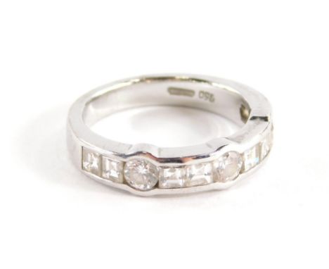 A Wempe diamond half hoop ring, channel set with eight square cut diamonds each approximately 3mm square totalling 1.14ct ass