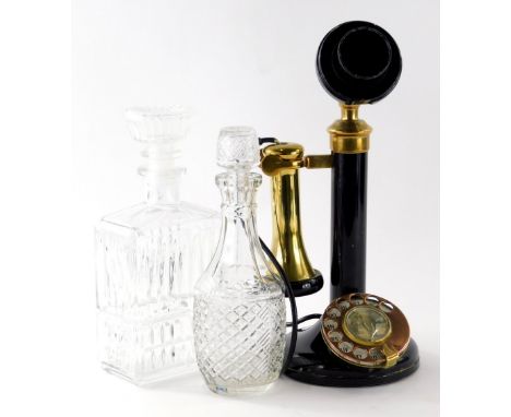 A reproduction candlestick telephone, with horn shaped brass receiver and front circular dial set with elephant, 34cm high, a