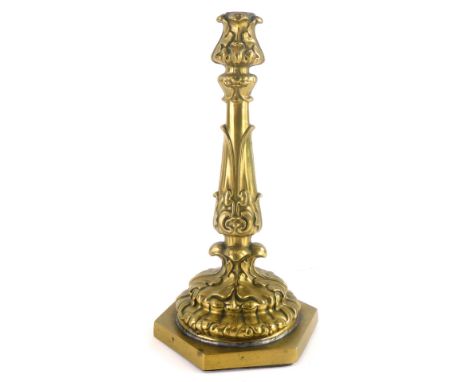 A late 19th/early 20thC gilt brass candlestick, decorated with leaves, drilled for electricity, 31cm high. (AF)