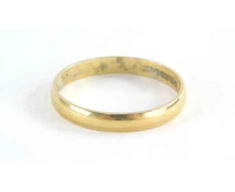 An 18ct gold wedding band, bearing the inscription lucky, Birmingham 1975, ring size Q½, 2.1g all in.