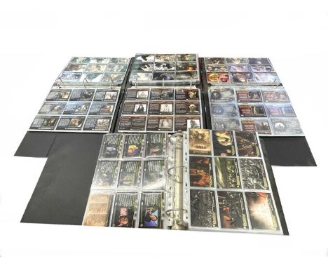 Mixed lot of folios containing a large quantity of Topps Lord of the Rings collectible cards. Featuring film stills, characte