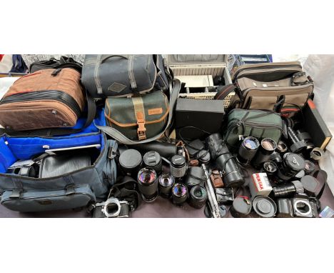 A Pentax ME Super camera body together with a collection of camera lenses including Vivitar, Sigma, Canon, etc, camera bags a