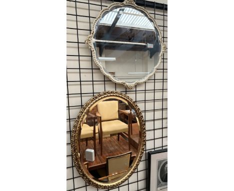 A gilt oval wall mirror together with a white and gilt wall mirror and two bookplates of architectural scenes 