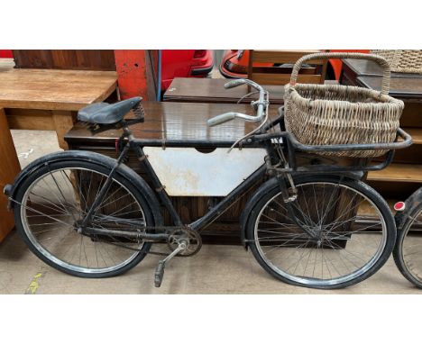 A Raleigh Tradesman's carrier bicycle with a carrier in the front, advertising panel, Dunlop seat in black