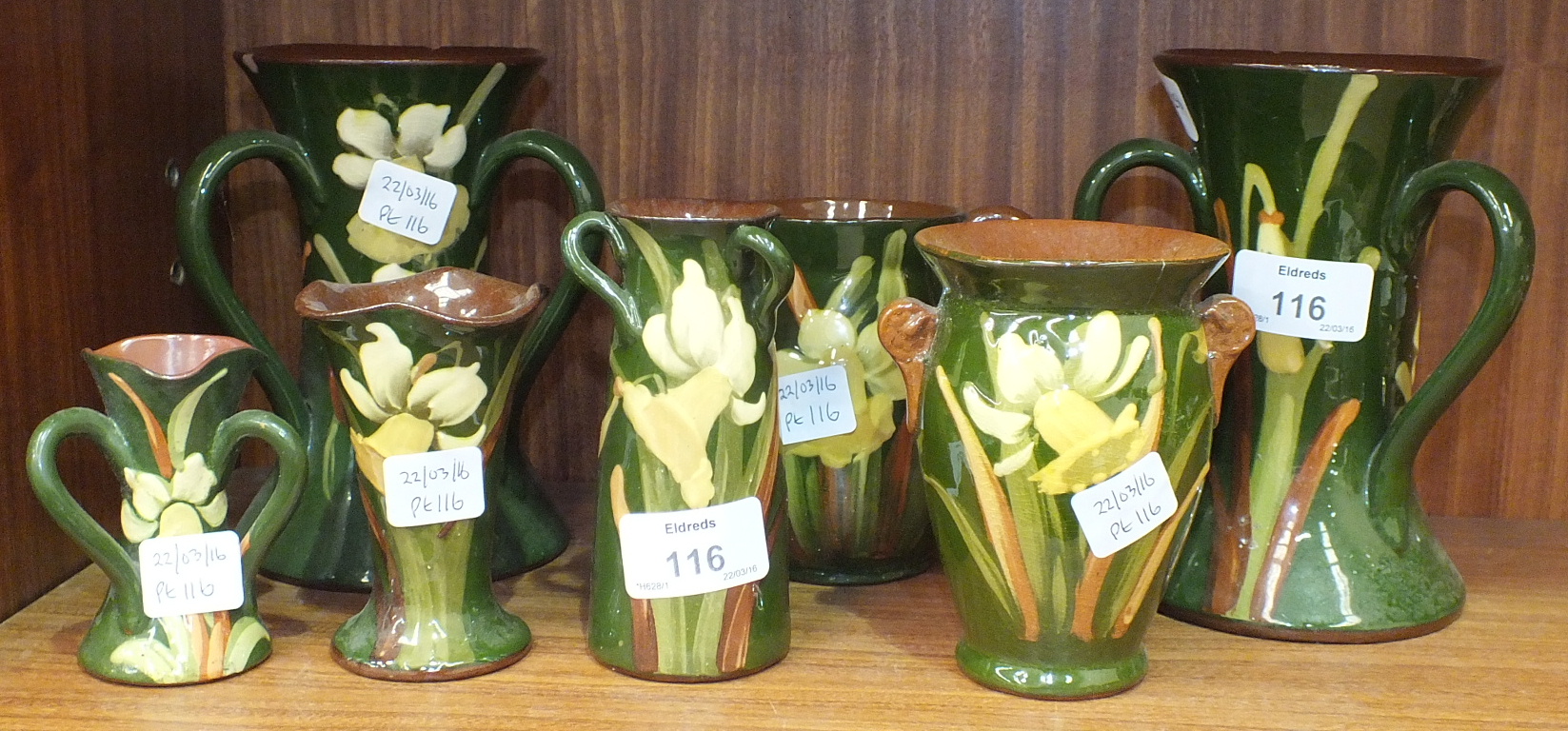 A pair of Longpark Torquay Pottery threehandled vases decorated with