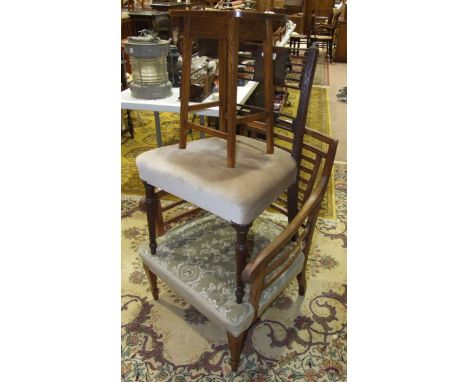 An early-20th century ladder-back armchair with upholstered seat, on tapering front legs with spade feet, a mahogany dining c