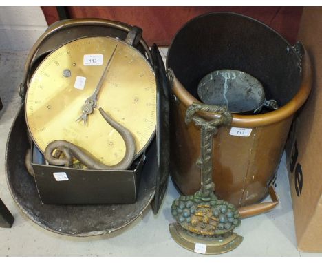 A Salters 20T brass and metal spring balance, a copper coal helmet, a metal doorstop in the form of a basket of fruit and flo