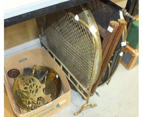 A circular brass-top table with folding wooden stand, a brass mesh fireguard and other brassware.