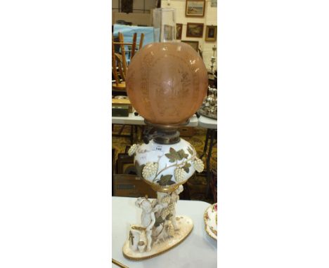 A late-Victorian Moore Brothers ceramic oil lamp, the reservoir with applied hops decoration above a figural column of two ch