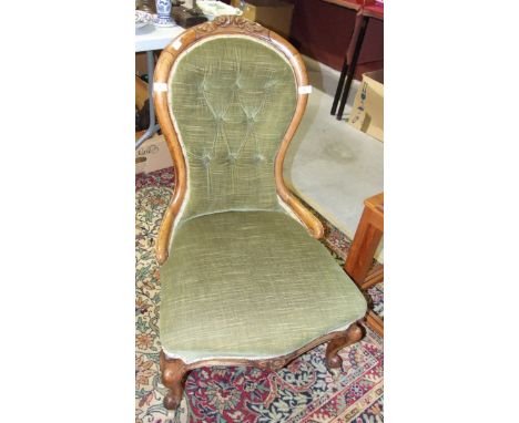 A Victorian mahogany-framed salon chair with upholstered seat and button back, on shaped front legs.