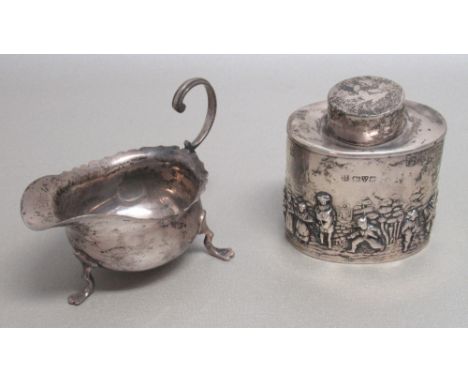 GEORGE V SILVER OVAL TEA CADDY CHASED AND EMBOSSED WITH FIGURES, CHESTER 1911 AND A SMALL SAUCE BOAT, BIRMINGHAM 1900, BOTH B