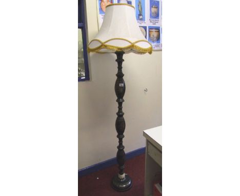 An Oriental ebonised metal standard lamp: with shade and fitting. 