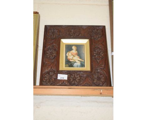 A print of Madonna and Child in carved wooden frame