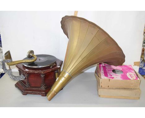 An old gramophone with metal hood and quantity of vintage records