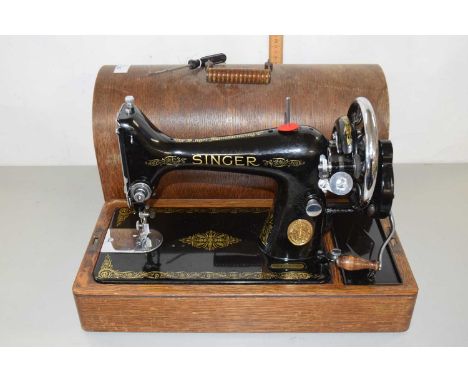 A vintage Singer sewing machine in wooden case