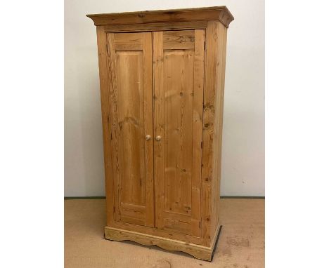 A rustic pine double wardrobe with single shelf and clothes rail to the interior, height 182cm, width 100cm, depth 50cm.