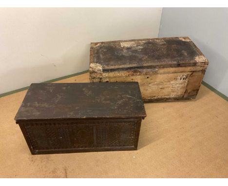 An oak coffer, height 42cm, width 89cm, depth 42cm, and a leather bound pine trunk in need of extensive repairs (2).