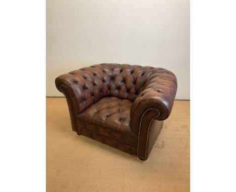A late 20th century brown leather Chesterfield button back armchair on castors, height 76cm, width 114cm, depth 83cm.Conditio