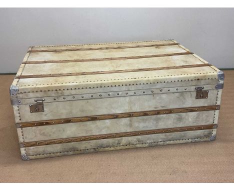 An early 20th century vellum trunk, beech bound, with linen interior, height 48cm, width 122cm, depth 90cm.
