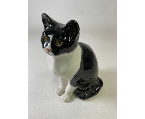 WINSTANLEY; a large ceramic black and white seated cat with yellow deep set glass eyes, size 6, marked to base, height 31cm.C