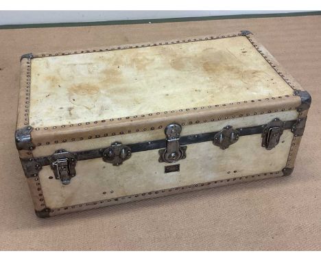 An early 20th century vellum travel trunk with metal banding, corners and studded exterior, height 35cm, width 92cm, depth 52