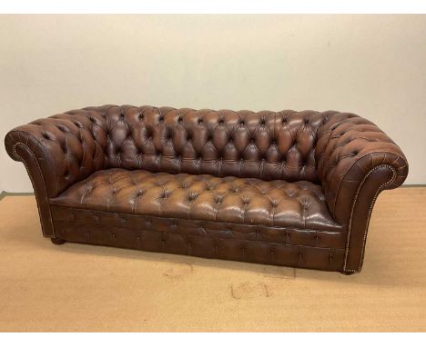 A late 20th century brown leather Chesterfield button back sofa on castors, height 76cm, width 205cm, depth 83cm.Condition Re