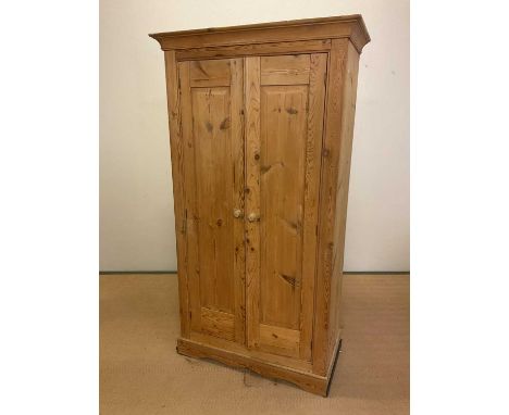 A rustic pine double wardrobe with single shelf and clothes rail to the interior, height 182cm, width 100cm, depth 50cm.