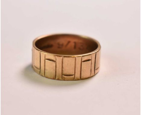A broad 9ct yellow gold wedding band with stylised Greek key detail, size R 1/2, approx 5.91g.