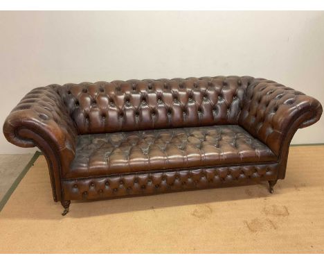 A mid 20th century brown leather button back Chesterfield sofa, height 80cm, width 220cm, depth 104cm.Condition Report: Overa