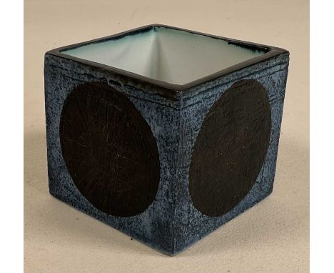 TROIKA; a cube vase with black circles to each side with a dark blue background, signed to the underside M D, height 8cm, wid
