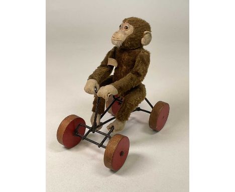 STEIFF; a circa 1940s pull along brown mohair monkey on wheels, 'Jocko', bearing label 'Made in US Zone', height 25cm