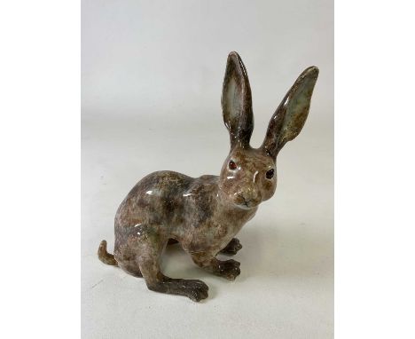 WINSTANLEY; a large ceramic seated hare with amber eyes in mottled brown glaze, size 7, signed to base, height 37cm.