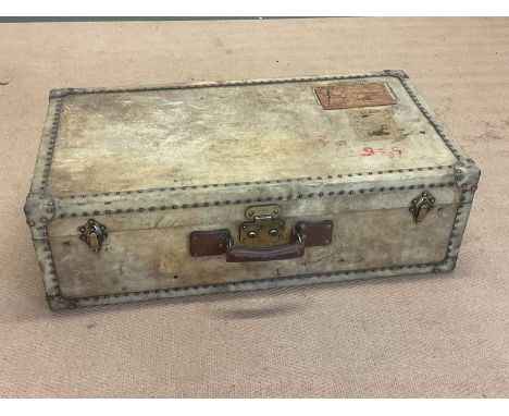 An early 20th century vellum travel trunk with leather and brass detailing to the exterior, height 25cm, width 80cm, depth 43