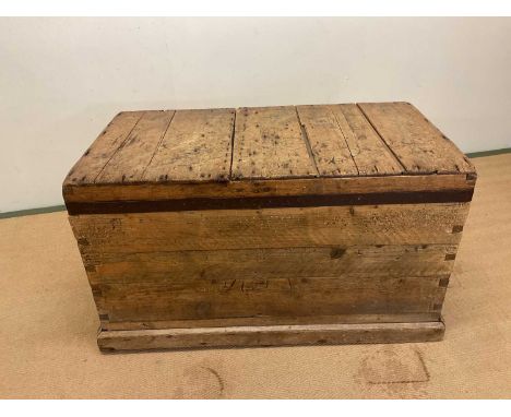 A pine trunk with metal banding, height 58cm, width 100cm, depth 54cm.