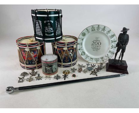 A Gurkha military figure and badges, a commemorative plate, notepapers, a swagger stick and three regimental ice buckets