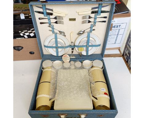 A Brexton picnic set, retailed by Harrods, virtually unused, 50 cm wide, a picnic set, in a case with basket weave style deco