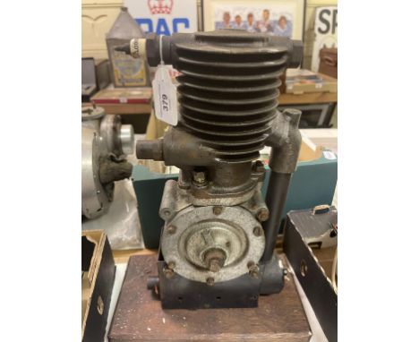 A Grigg small capacity single cylinder engine, stamped 58, on a stand 