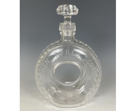 A novelty ‘When Tyred, Scotch’ cut glass whisky decanter, pre-war, in the form of an early motorcar tyre, with facet-cut trea