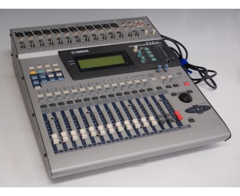 A 1990s Yamaha 01v digital mixing console, with owner's manual