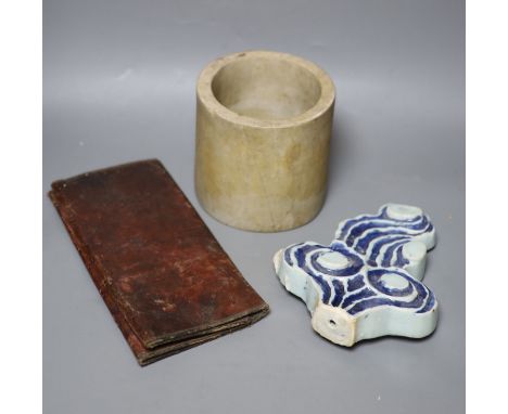 A Chinese blue and white Ming porcelain finial, a leather wallet. c.1920 and a cream stone cylinder, longest 29cm