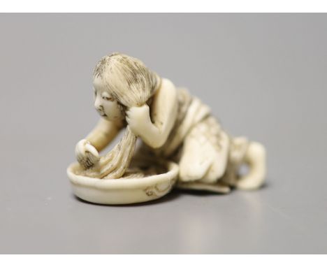 A 19th century Japanese ivory netsuke of a woman washing her hair, 3.5cm wide